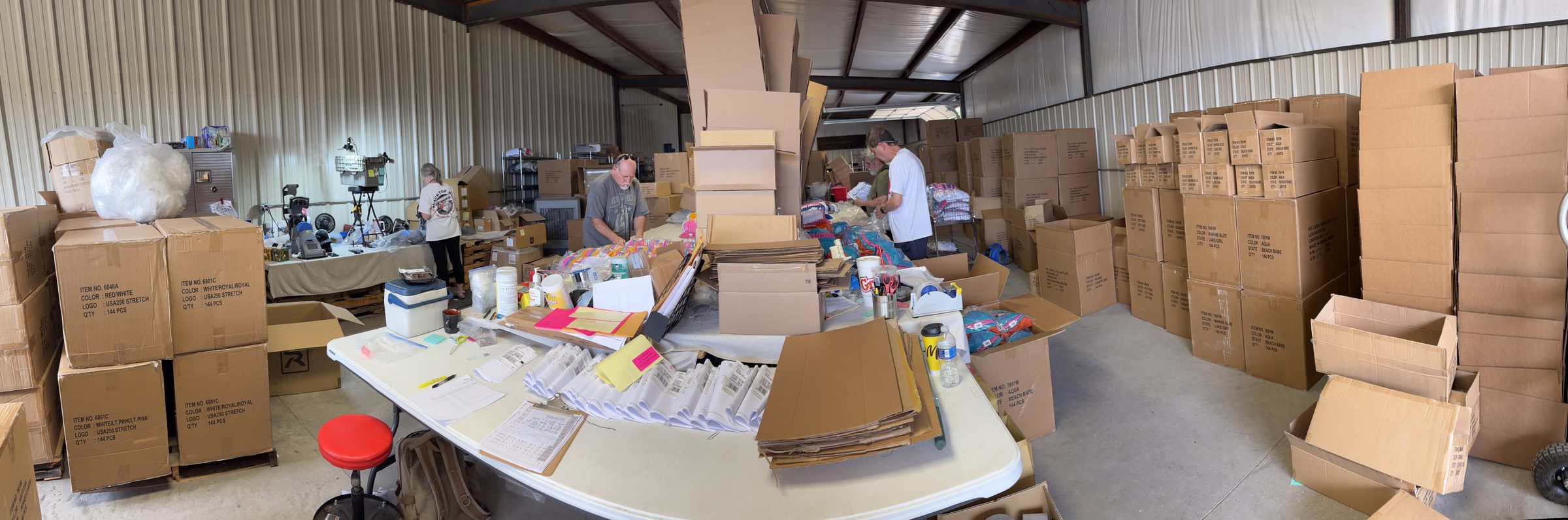 The TFN crew packing and checking hat orders by hand in Yukon, Oklahoma